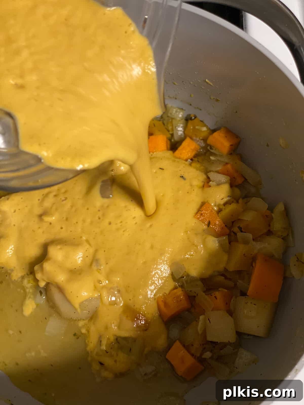 Golden Roasted Delicata Sweet Potato Soup 16 Process shot of adding blended soup back to the pot