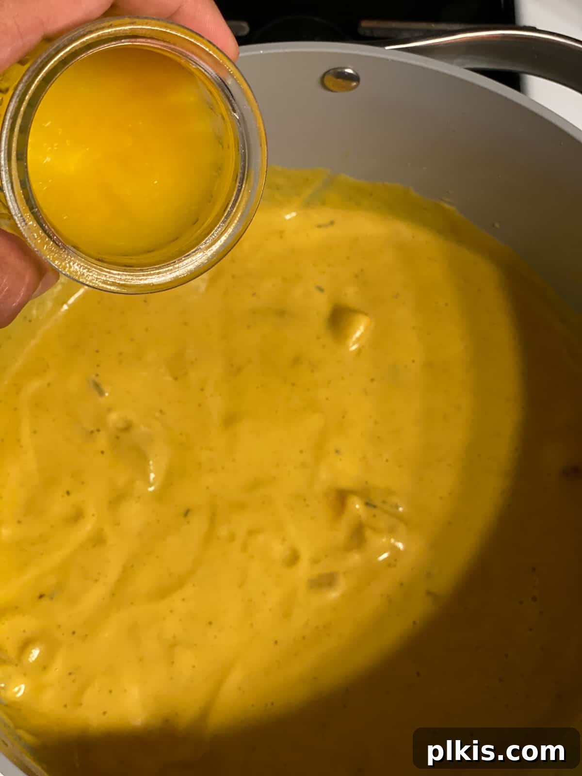 Golden Roasted Delicata Sweet Potato Soup 17 Process shot of adding blended soup back to the pot before serving