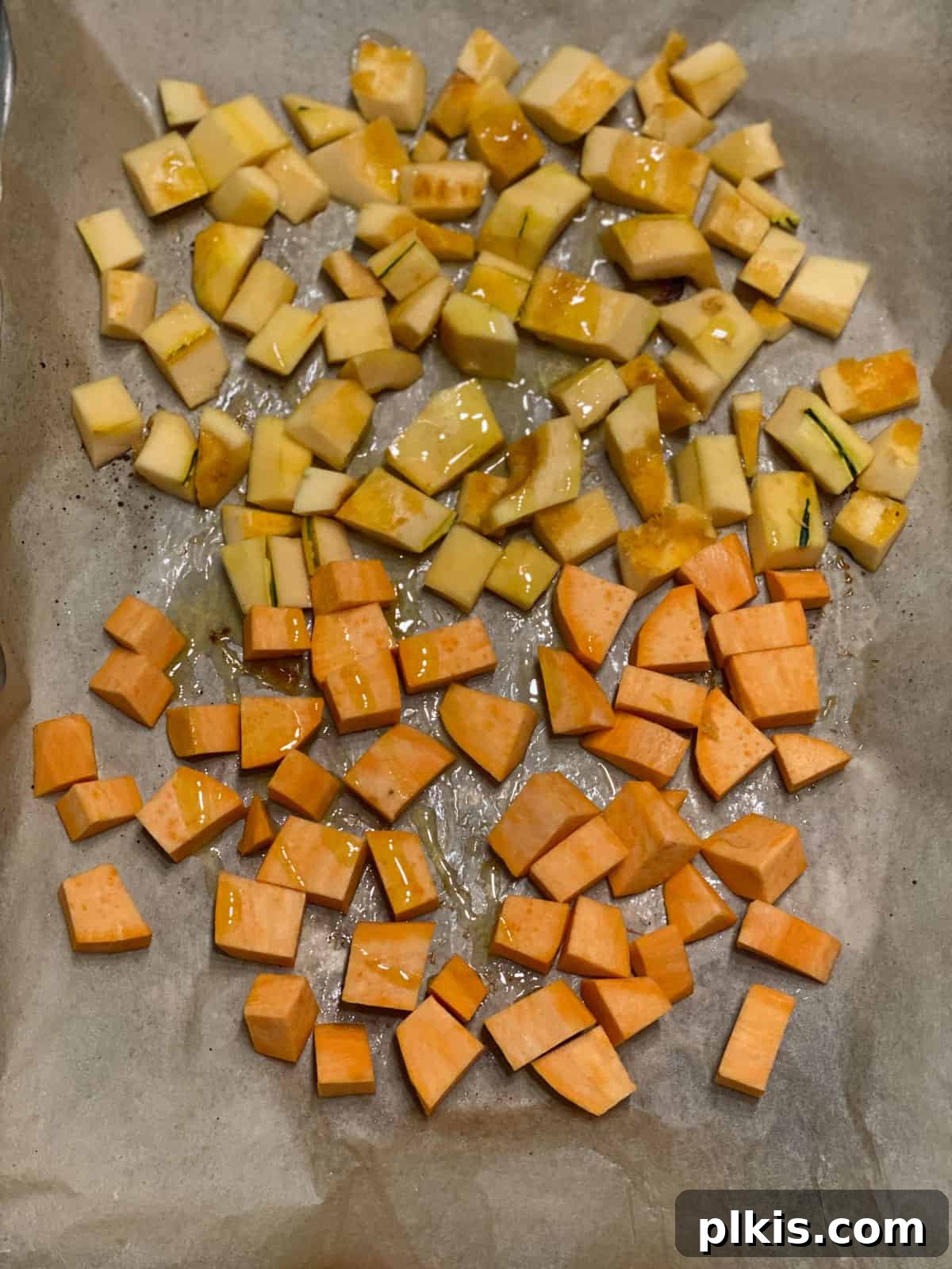 Golden Roasted Delicata Sweet Potato Soup 4 Process shot of roasting diced squash and sweet potato on a baking tray