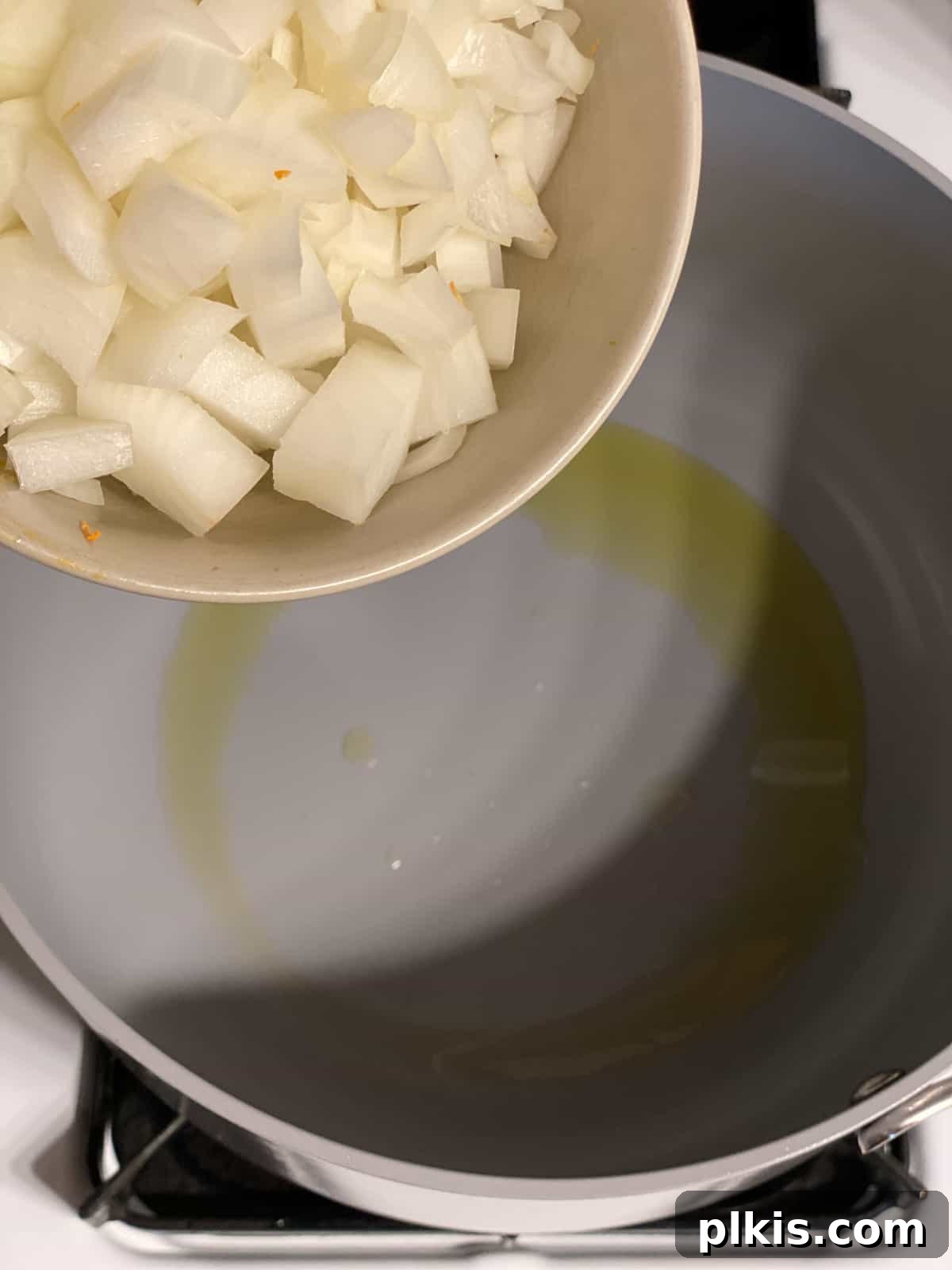 Golden Roasted Delicata Sweet Potato Soup 5 Process shot of adding diced onions to the pan to sauté