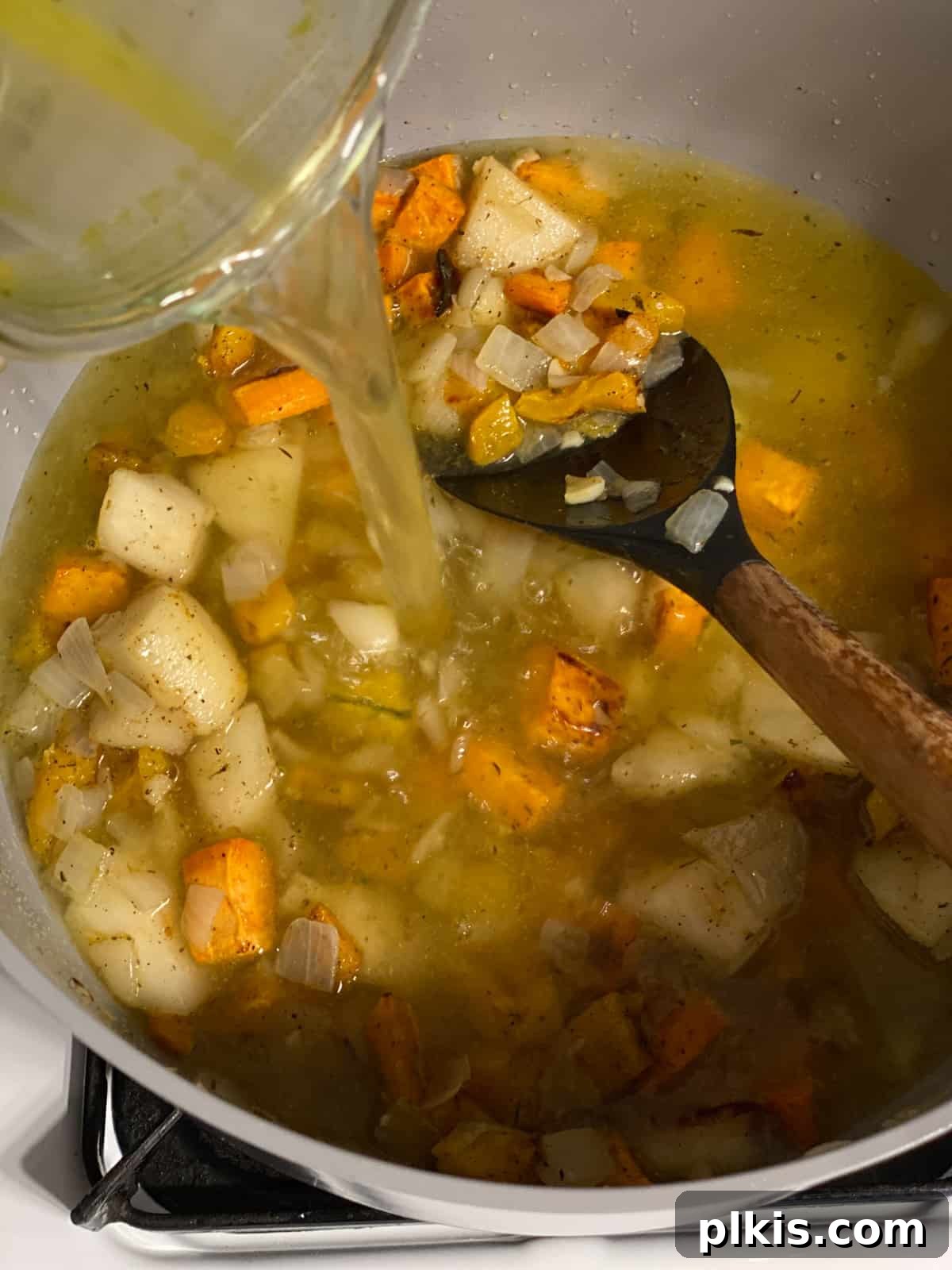 Golden Roasted Delicata Sweet Potato Soup 10 Process shot of mixing in vegetable broth to the soup pan