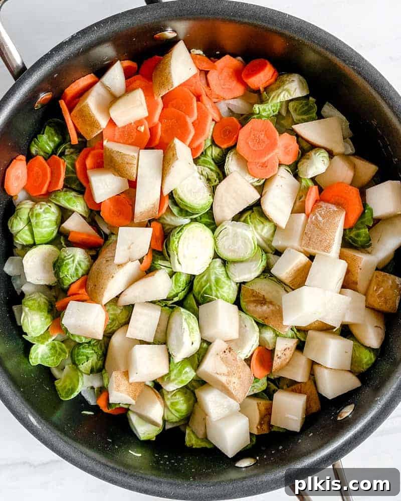Aromatic Brussels Sprouts Curry 5 Brussels sprouts and potatoes being added to the sautéed aromatics in a pan, ready to be coated in the burgeoning flavors of the curry base.