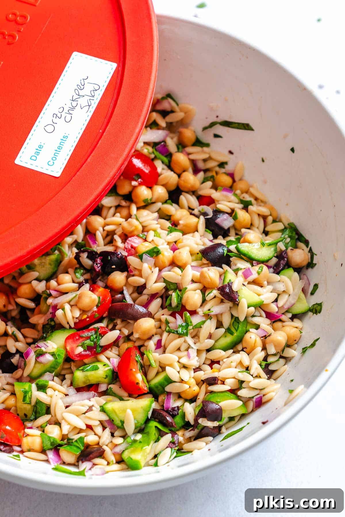 Zesty Lemon Orzo Salad 9 Completed Easy Lemon Orzo Salad stored in a clear airtight container, ready for meal prep or refrigeration.