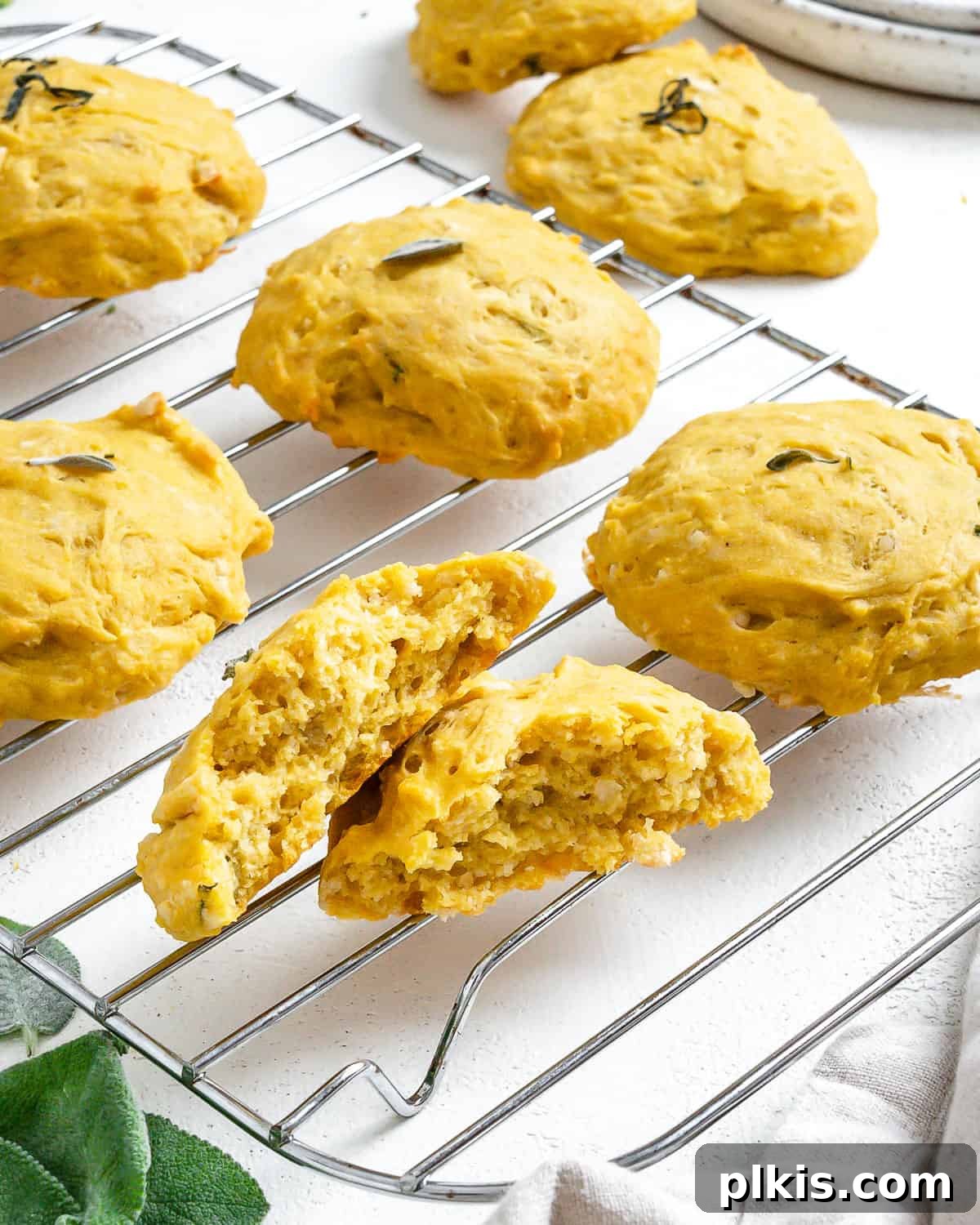 Golden Sage Butternut Biscuits 12 More Butternut Squash Sage Biscuits on a wire rack, showcasing their golden color and flaky texture.