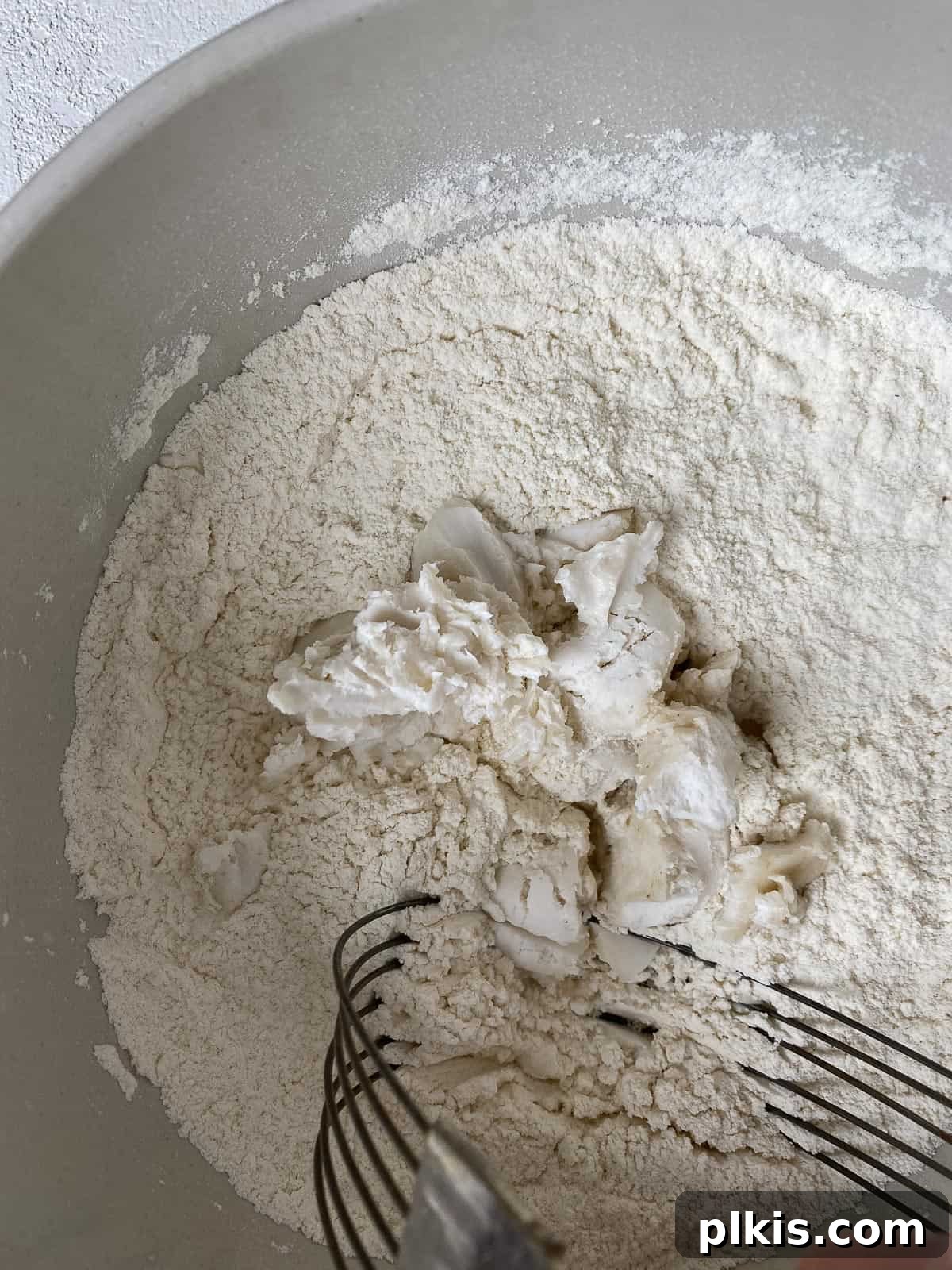 Golden Sage Butternut Biscuits 6 Cold vegan butter being cut into the flour mixture with a pastry cutter until crumbly.