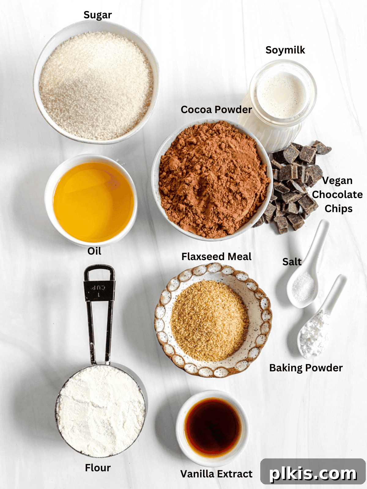 Heavenly Vegan Brownies 3 ingredients for Super Fudgy Vegan Brownies measured out on a white surface, including flour, cocoa powder, sugar, and plant milk