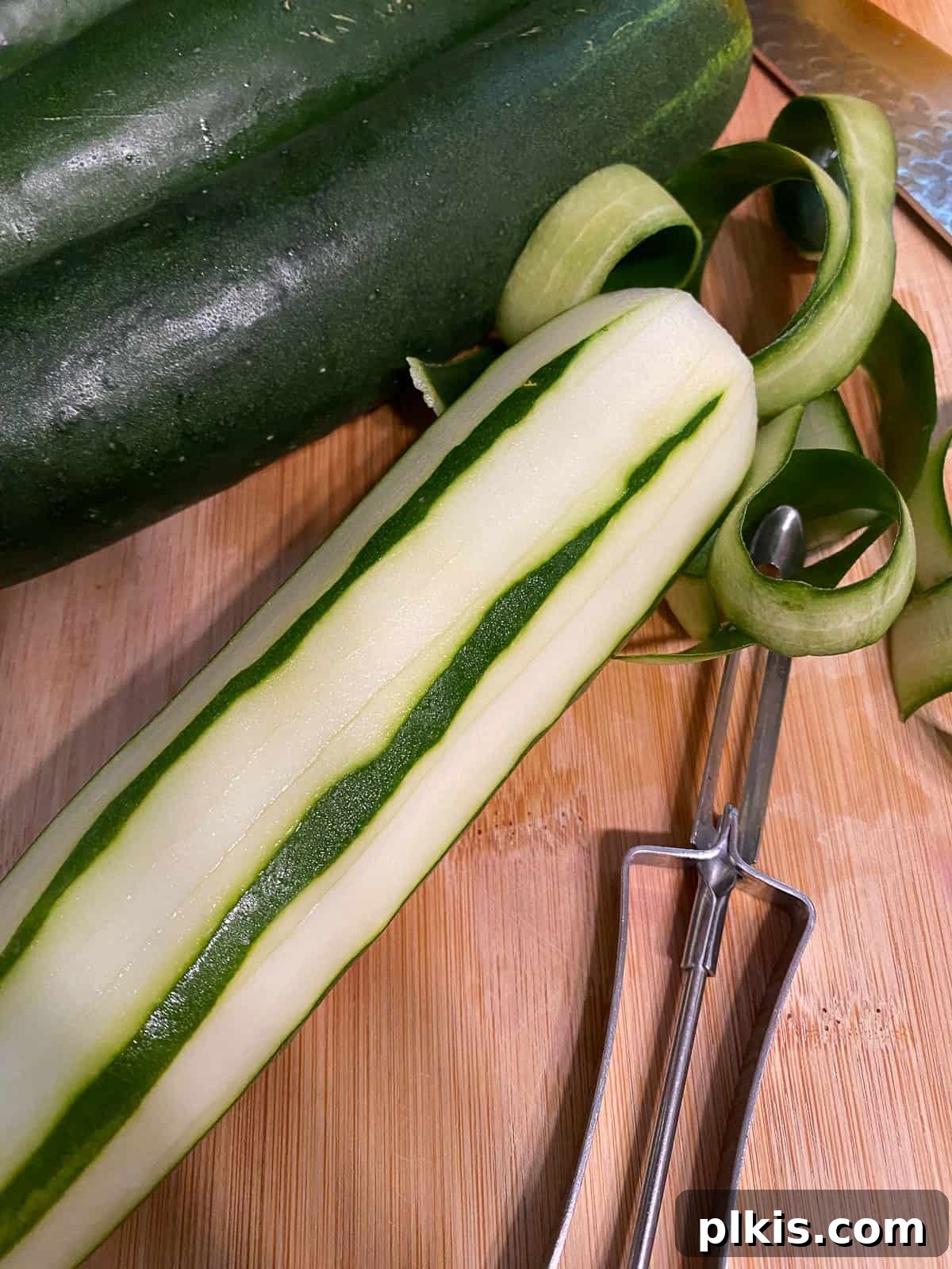Refreshing Cucumber & Chive Sunflower Cream Bites 6 Process shot demonstrating peeling of cucumber to create a striped effect.