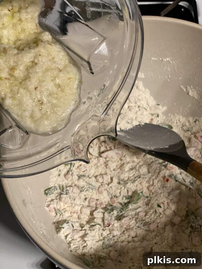 Crispy Vegan Potato Pancakes 7 The blended potato and leek mixture being added to the bowl of dry ingredients.