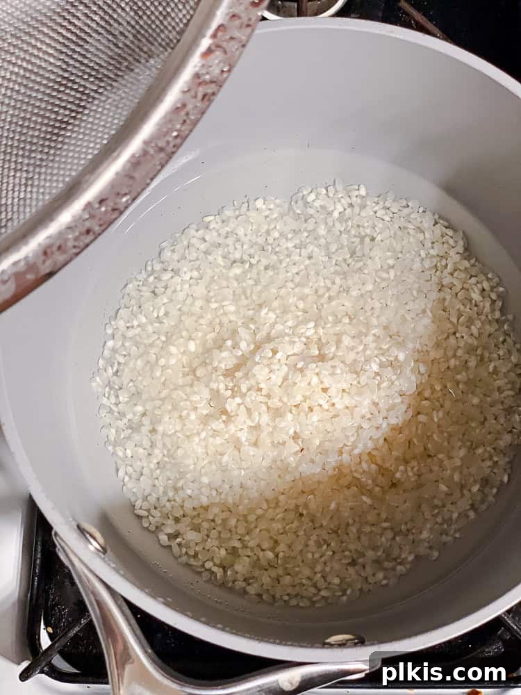 Unrolled Sushi 4 Sushi rice being cooked in a grey pot on a stovetop, perfectly steaming.
