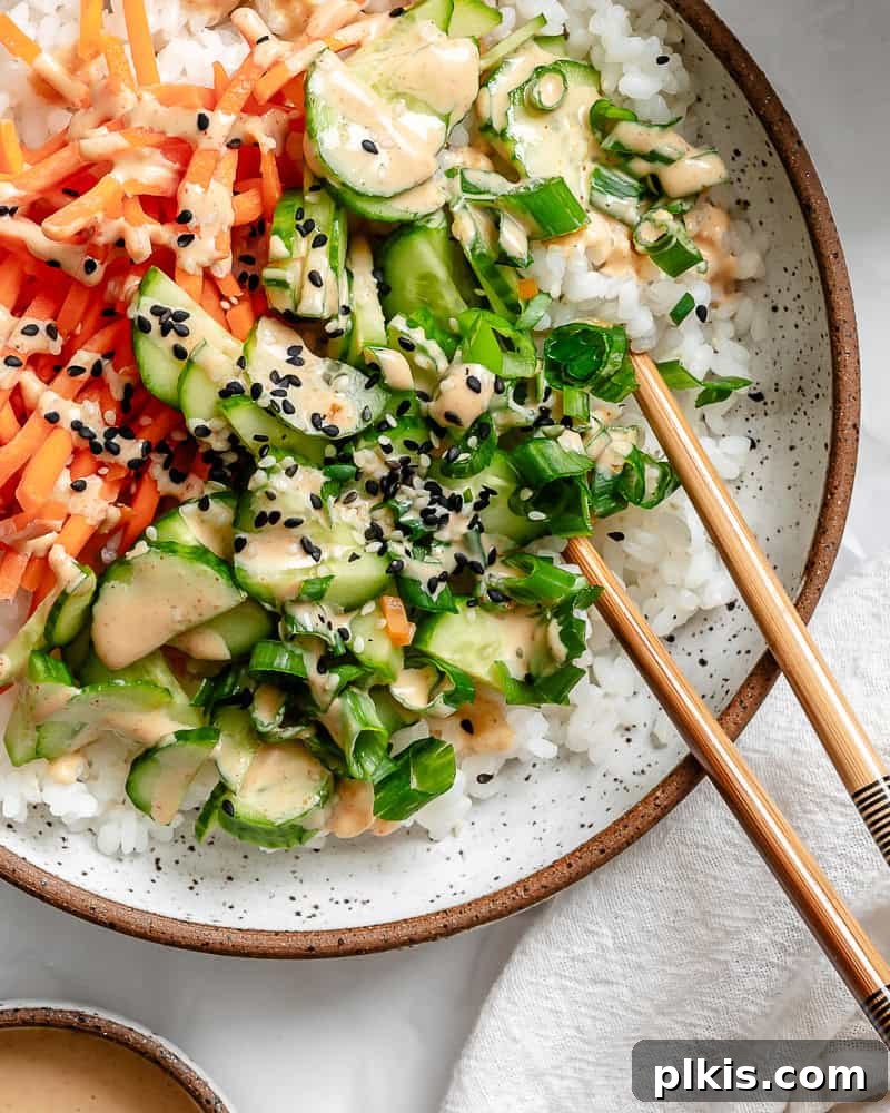 Unrolled Sushi 9 A perfectly plated vegan sushi bowl, showcasing a beautiful arrangement of rice, colorful vegetables, tofu, and a delicate drizzle of spicy mayo.