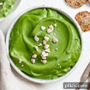 Completed vegan spinach dip against a light background, perfectly creamy and ready to be served, highlighting its rich texture and inviting presentation.