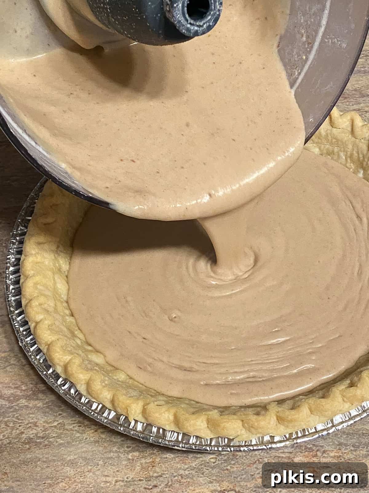 Velvet Vegan Banana Cream Pie 6 process shot of pouring Vegan Banana Cream Pie ingredients into pie crust