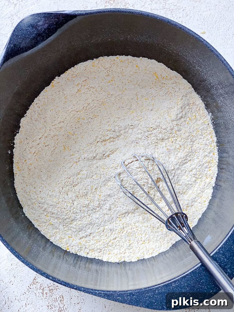 Zesty Jalapeño Cornbread 7 whisking the dry ingredients for Vegan Jalapeño Cornbread in a large bowl.