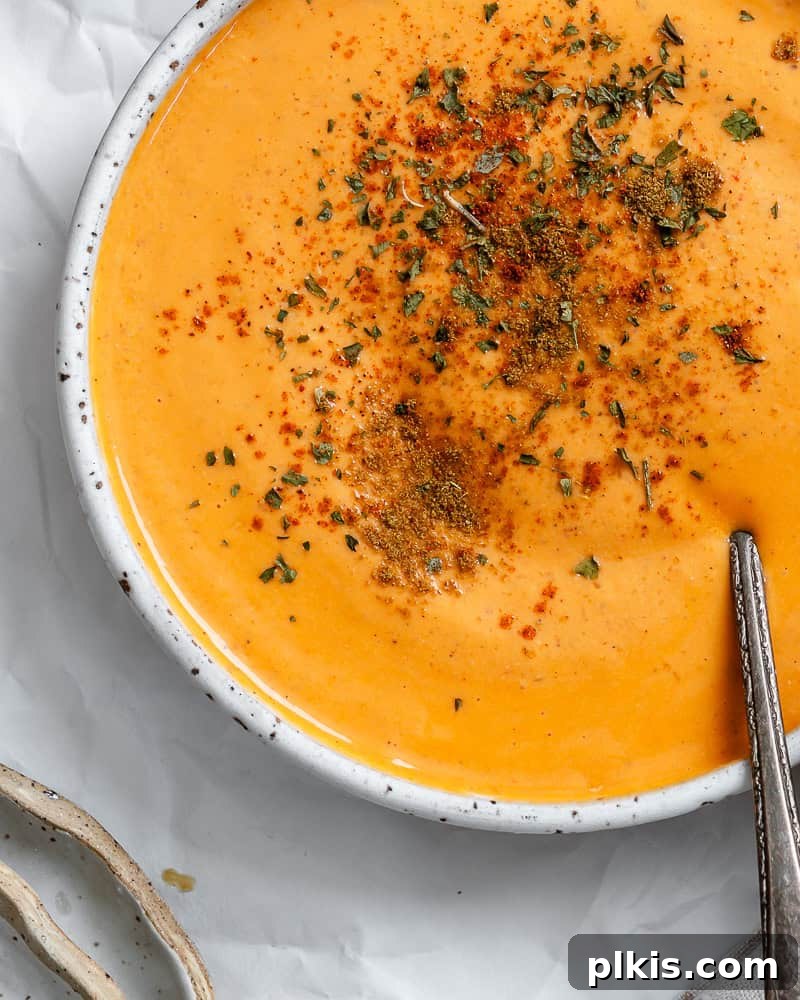Smoky Roasted Red Pepper Hummus 6 completed Roasted Red Pepper Hummus in a decorative bowl, topped with a swirl of olive oil and fresh herbs