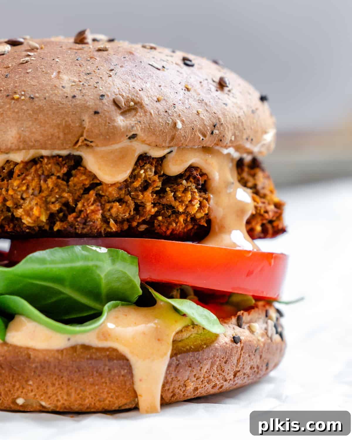 Ultimate Vegan Lentil Burgers 2 Delicious Vegan Lentil Burgers on a white surface, ready to be served.