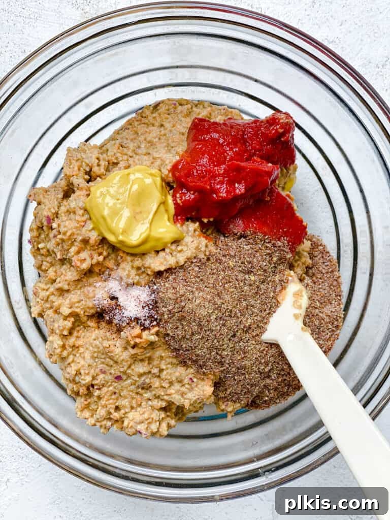 Ultimate Vegan Lentil Burgers 12 Process shot of mixing ingredients for lentil burgers in a bowl.