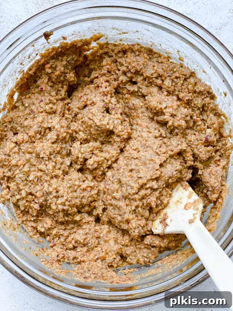 Ultimate Vegan Lentil Burgers 13 Further process shot of mixing ingredients in a bowl, ensuring thorough combination.