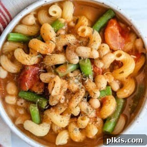 completed Pasta Bean and Tomato Soup in a white bowl against a light surface