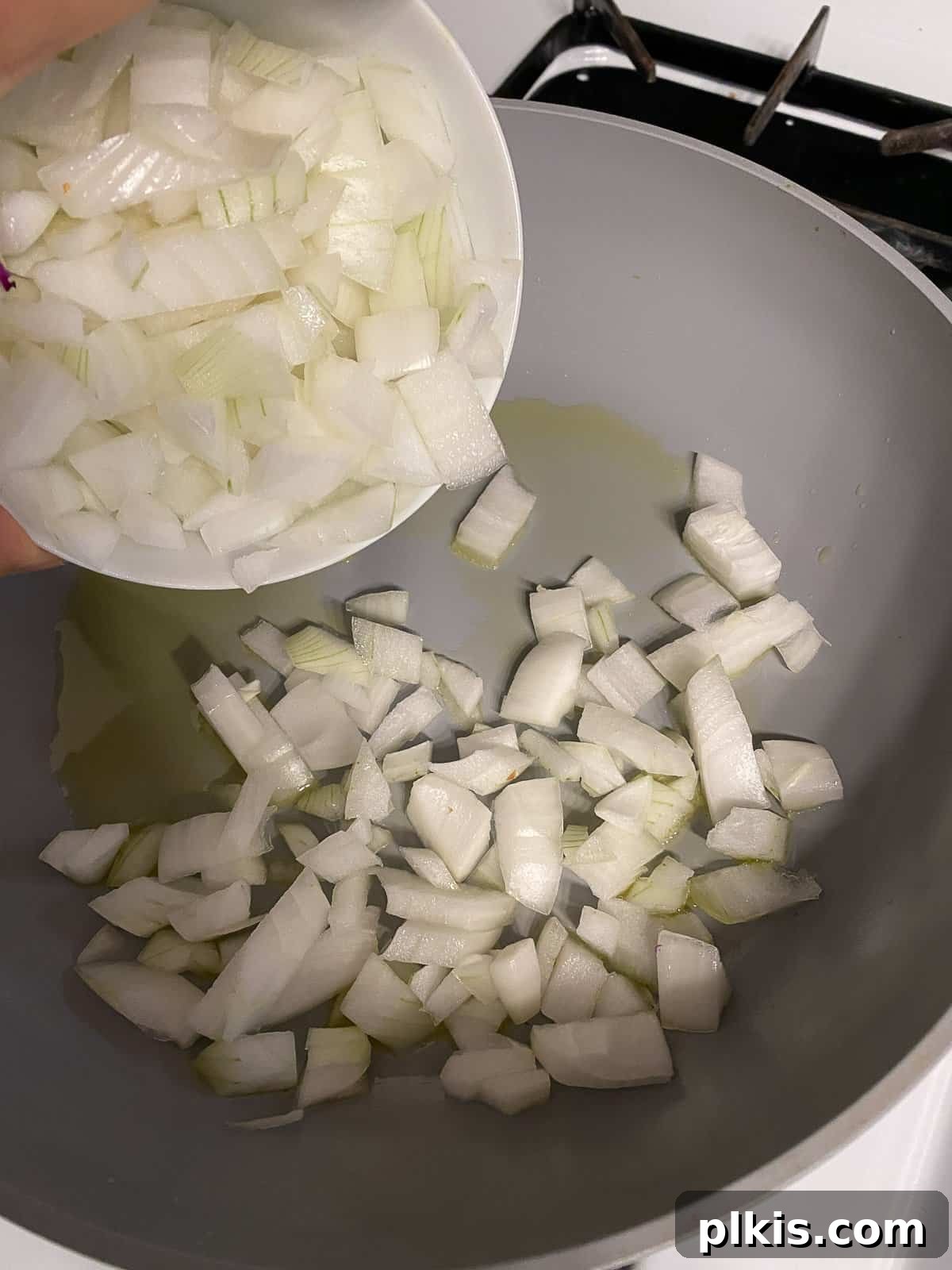 Garden Fresh Vegan Coleslaw with Apple, Carrots, and Corn 4 process of adding cut onion to pan