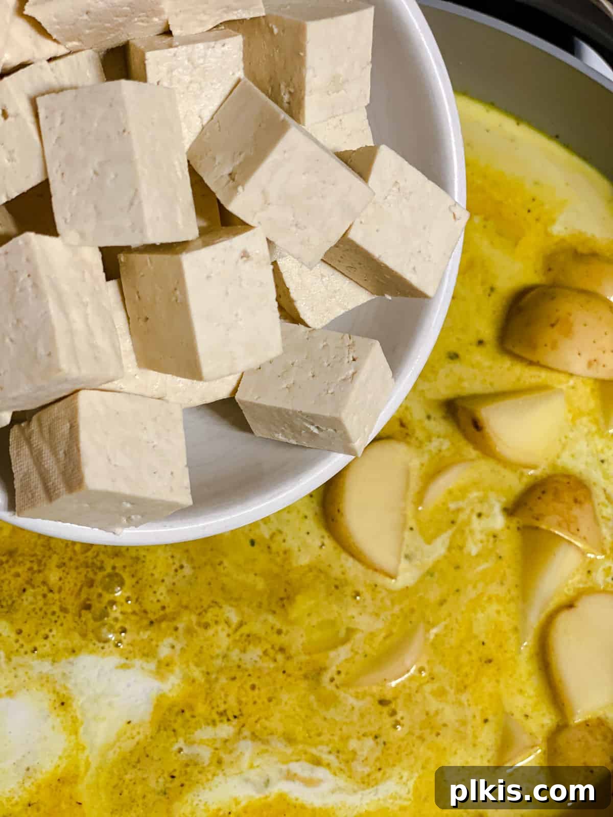 process shot of adding tofu to pan