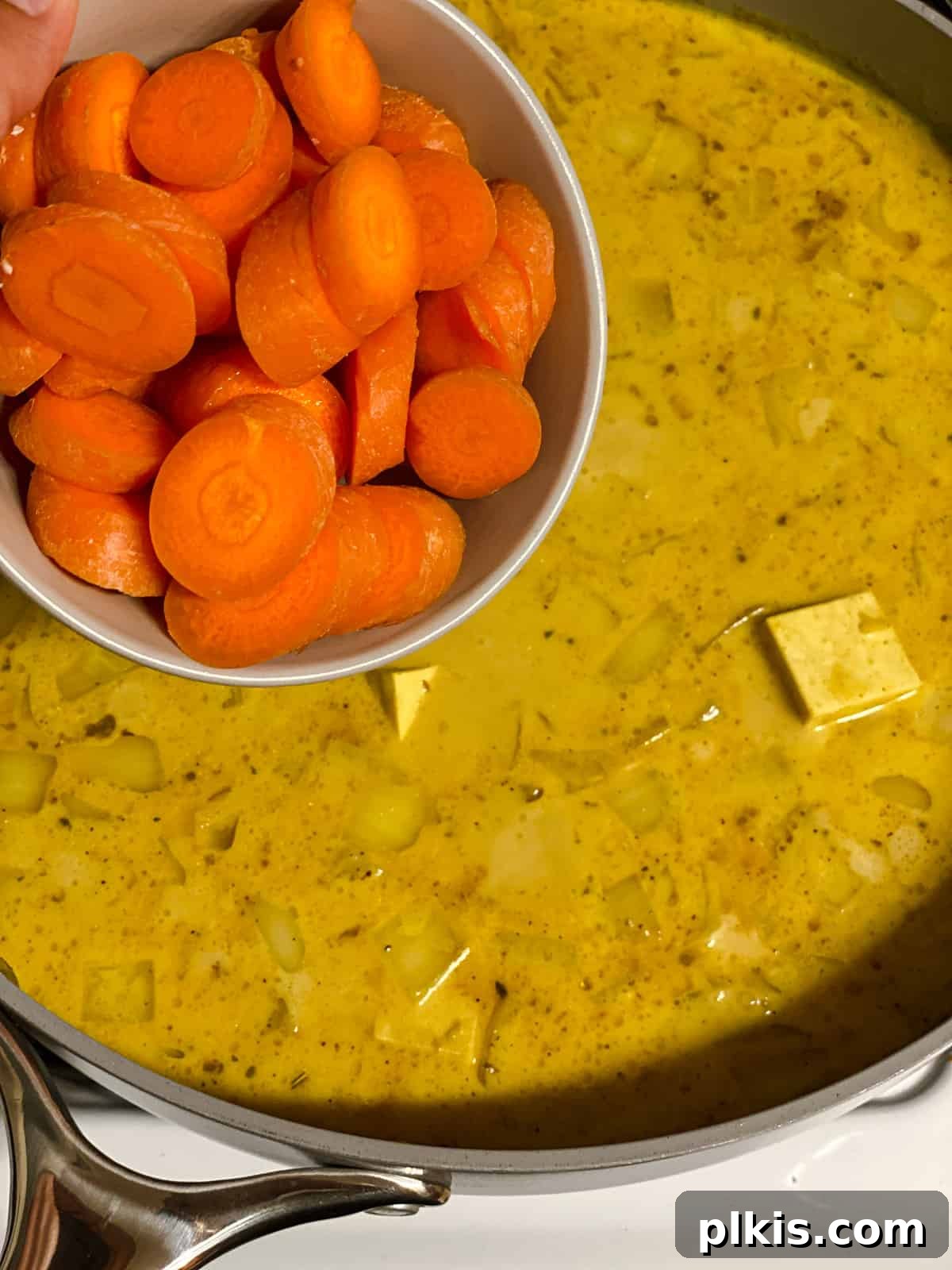 process shot of adding carrots to pan