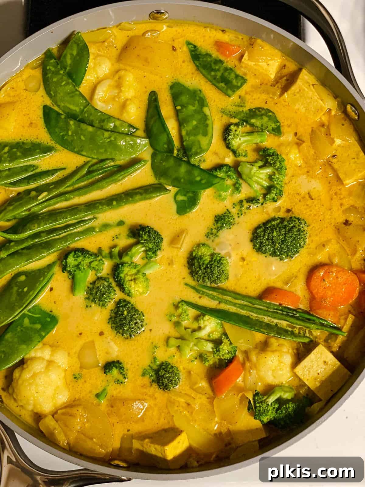 process shot of mixing ingredients together in pan