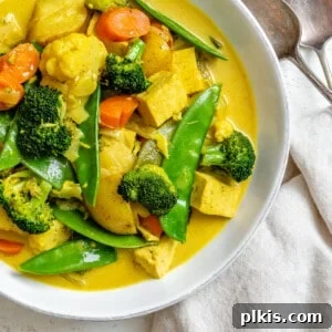 completed Easy Tofu Vegetable Coconut Curry in a bowl against a white background