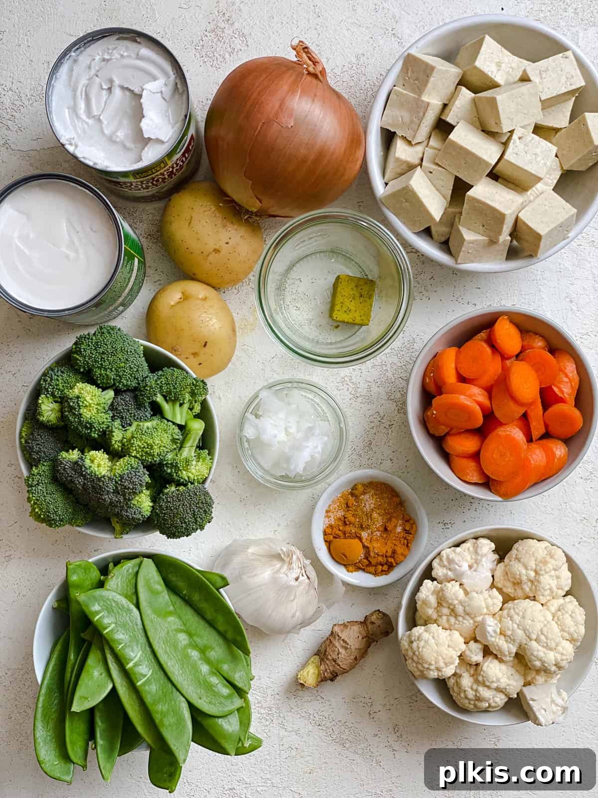 ingredients for Easy Tofu Vegetable Coconut Curry measured out against a white surface