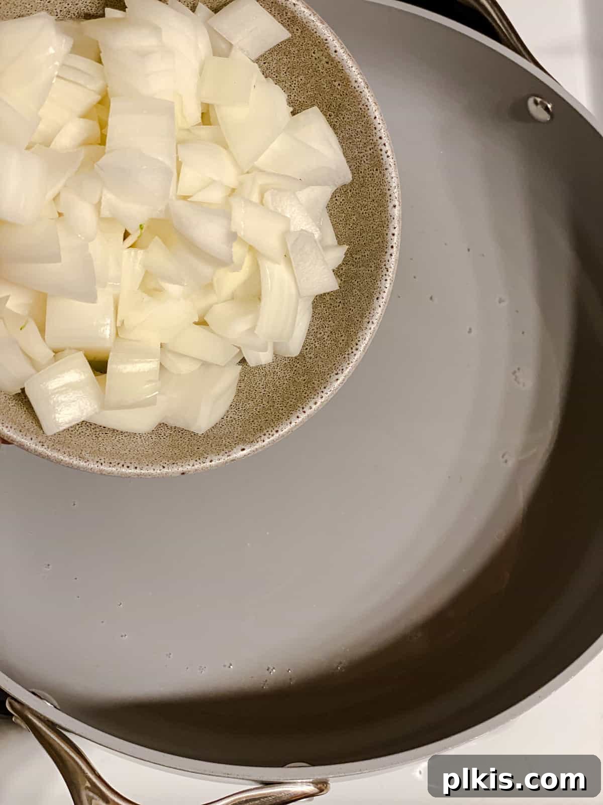 process shot of adding onions to pan