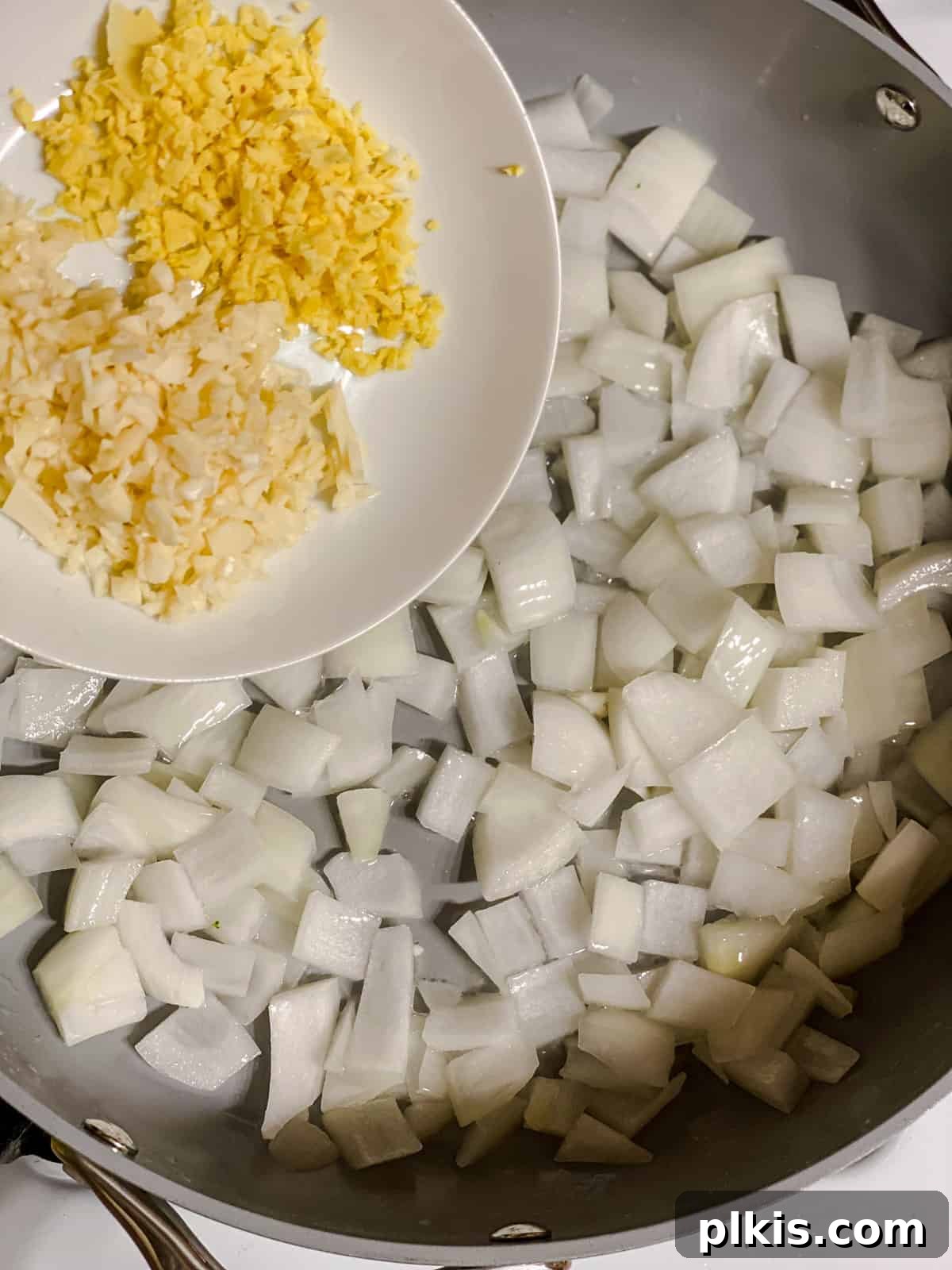 process shot of adding garlic to pan