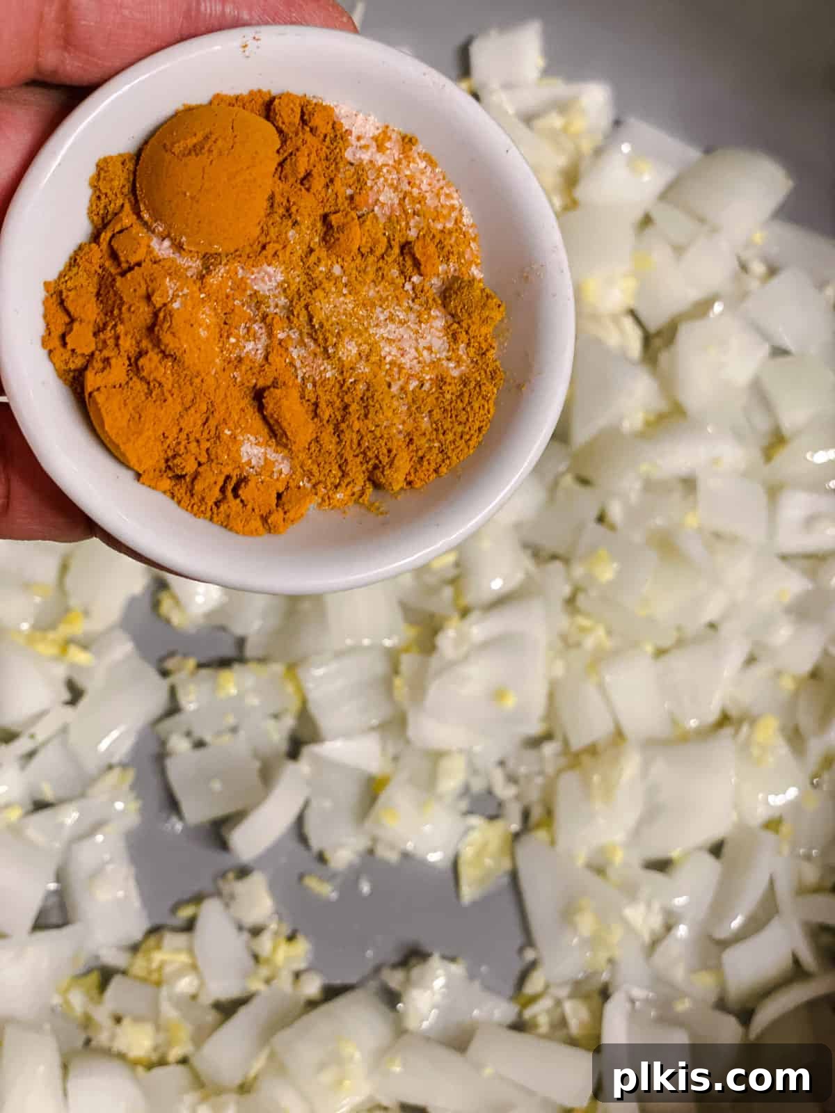 process shot of adding spices to pan