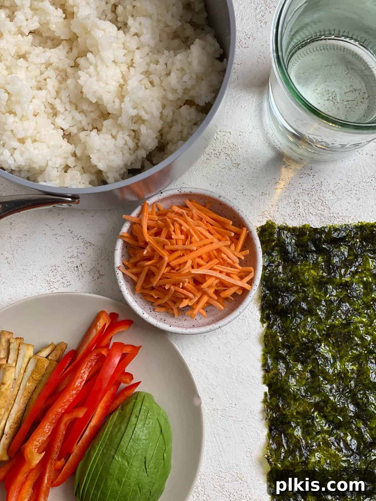 Plant-Powered Sushi Rolls 12 ingredients for Vegan Sushi Rolls with Crispy Tofu measured out against a light surface