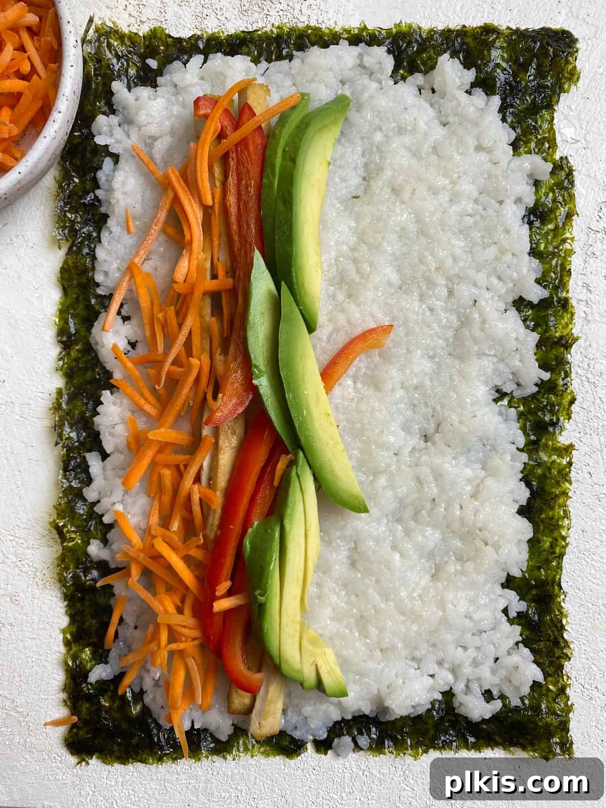 Plant-Powered Sushi Rolls 14 process shot of layering veggies on sushi and seaweed