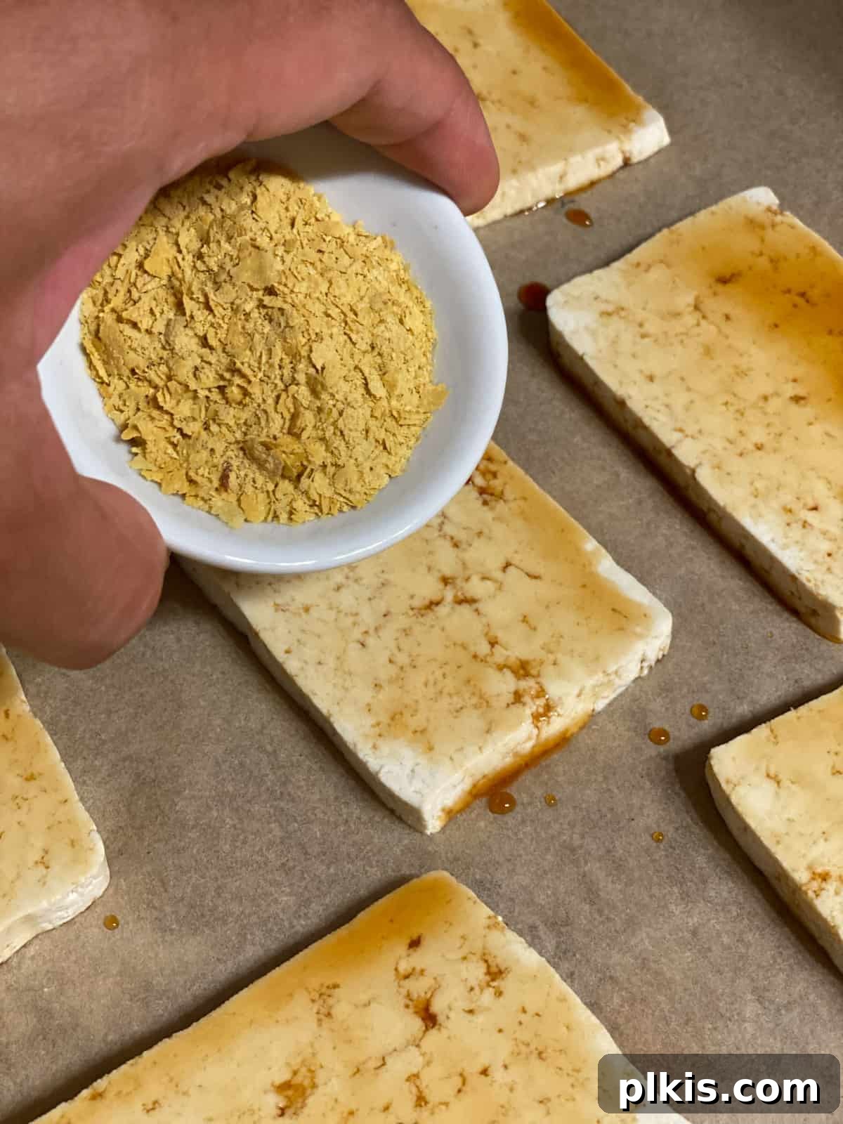 Plant-Powered Sushi Rolls 8 process shot of adding nutritional yeast to tofu slices
