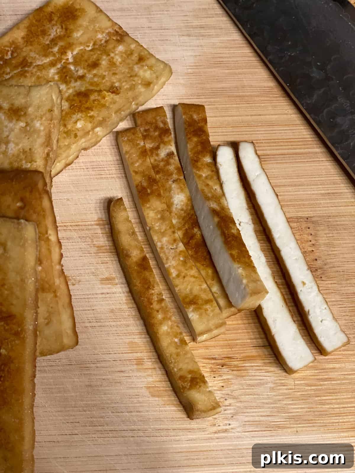 Plant-Powered Sushi Rolls 10 process shot of further slicing tofu into strips
