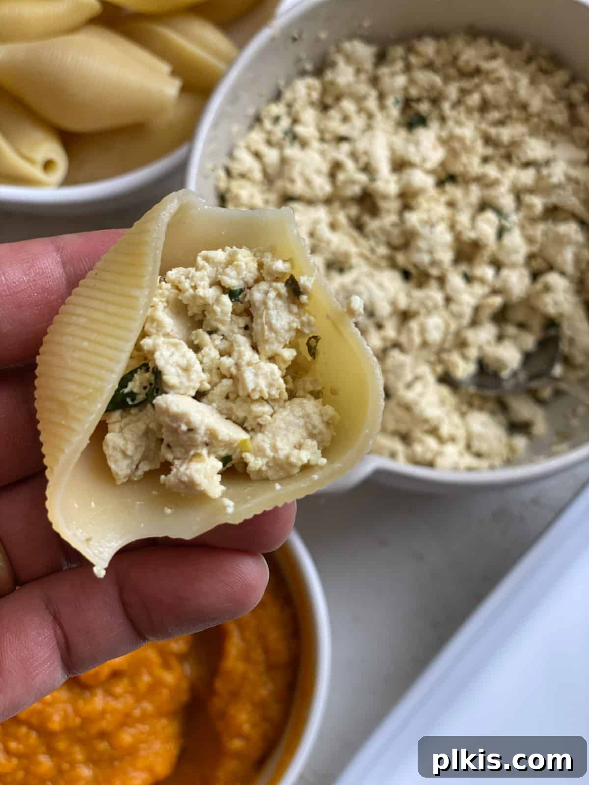 Autumn Pumpkin Pasta Shells with Aromatic Sage Cream 11 Close-up of tofu ricotta being added to a pasta shell