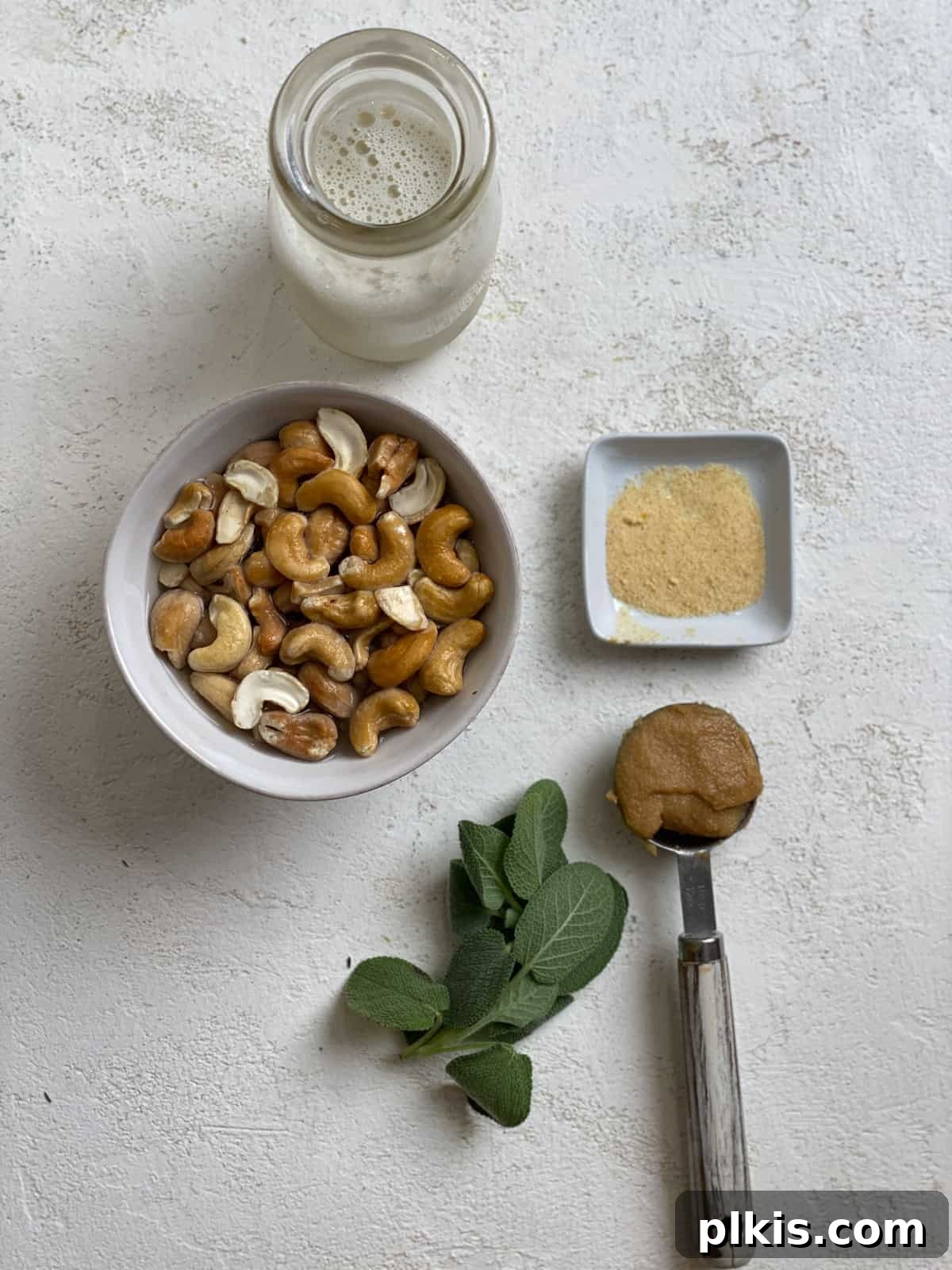 Autumn Pumpkin Pasta Shells with Aromatic Sage Cream 14 Ingredients for Sage Cashew Cream laid out on a white surface