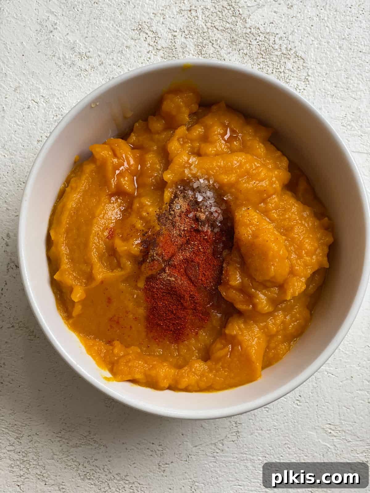 Autumn Pumpkin Pasta Shells with Aromatic Sage Cream 10 Pumpkin puree and spices being mixed together in a bowl