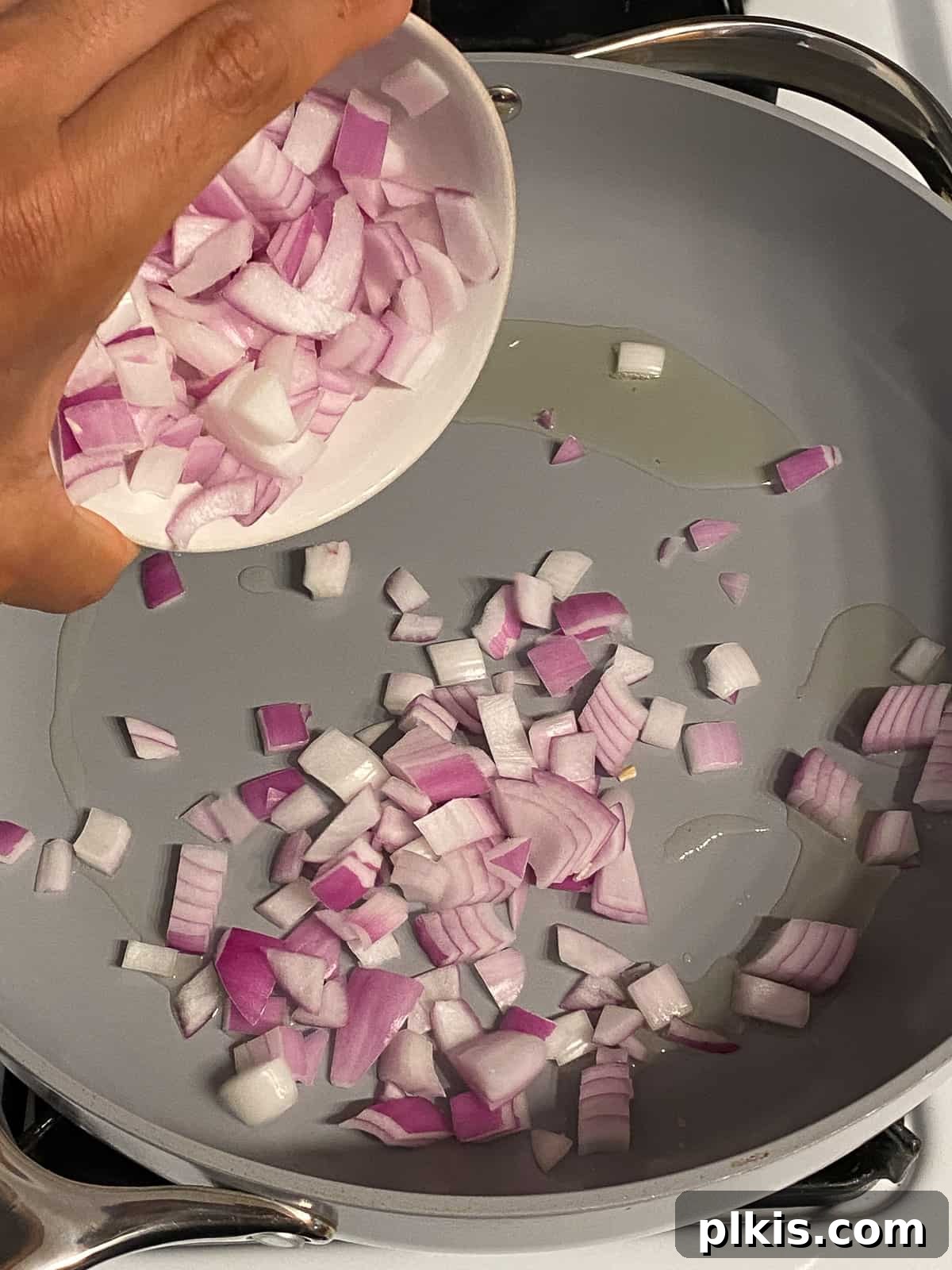 Roasted Cauliflower Tacos 7 Diced onions being added to a hot pan, beginning the sauté process to build the foundational flavor for the taco filling.