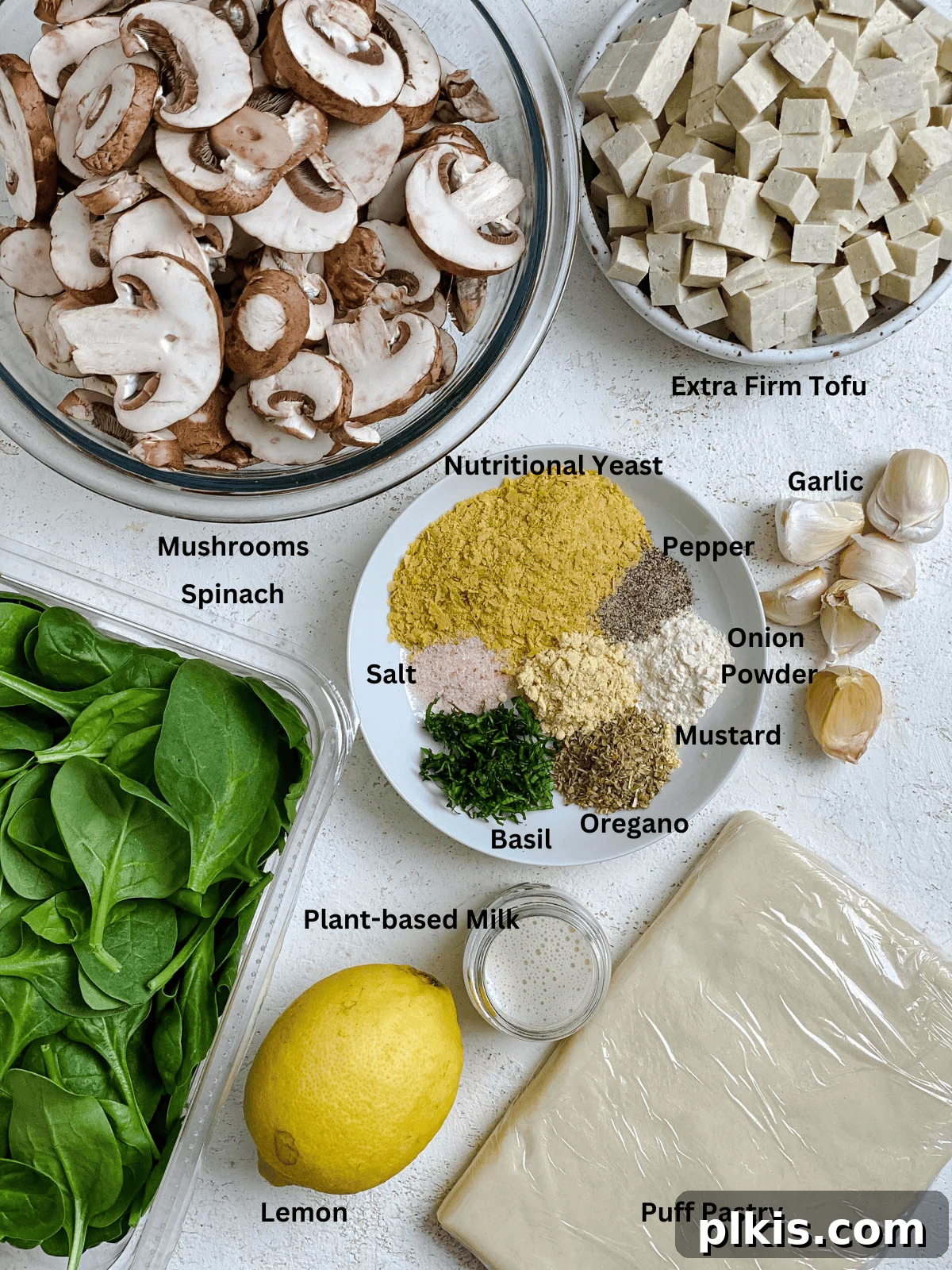Savory Vegan Spinach Mushroom Pockets 3 Ingredients for Spinach Mushroom Pockets measured out on a white surface.