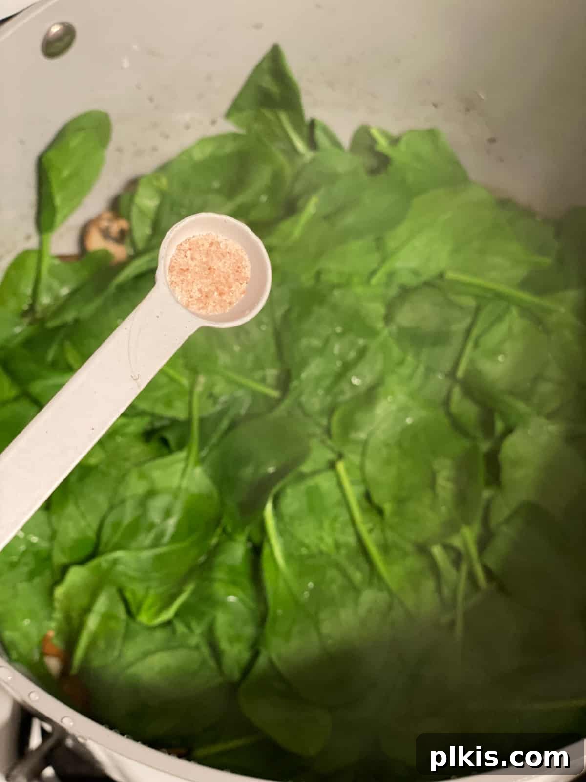 Savory Vegan Spinach Mushroom Pockets 5 Process shot of adding salt to pan.