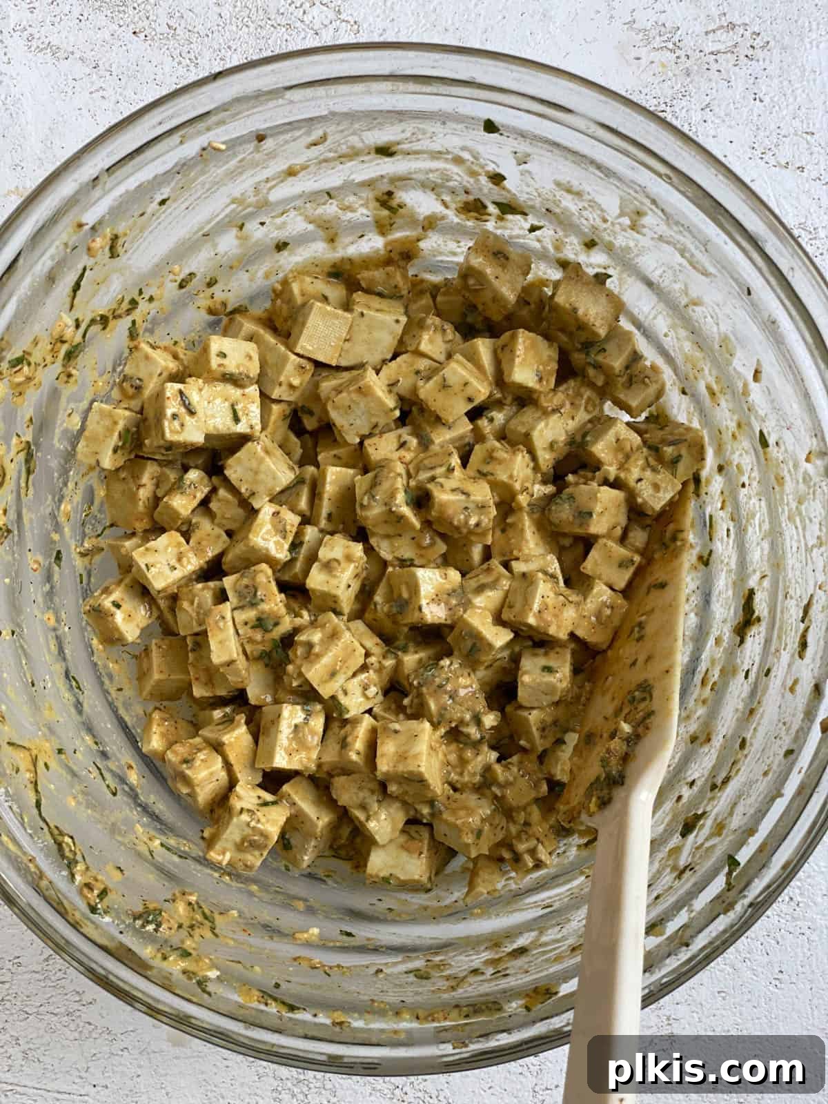 Savory Vegan Spinach Mushroom Pockets 6 Process shot of mixing tofu mixture in a bowl.