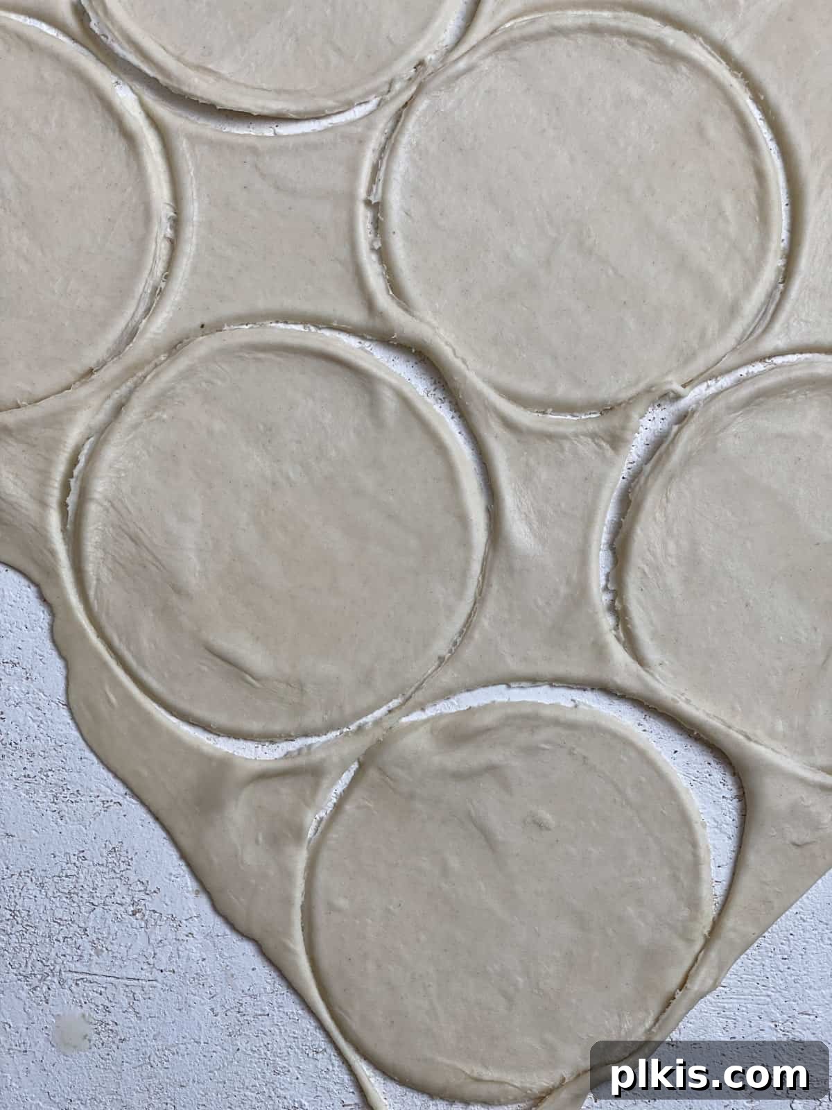 Savory Vegan Spinach Mushroom Pockets 7 Process shot of making circular pieces of dough.