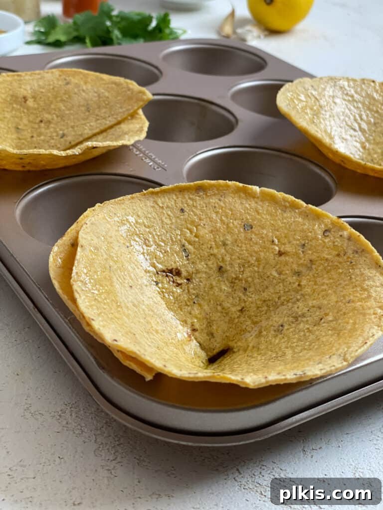 Zesty Black Bean Crunch Cups 5 process of adding tortillas to muffin tin