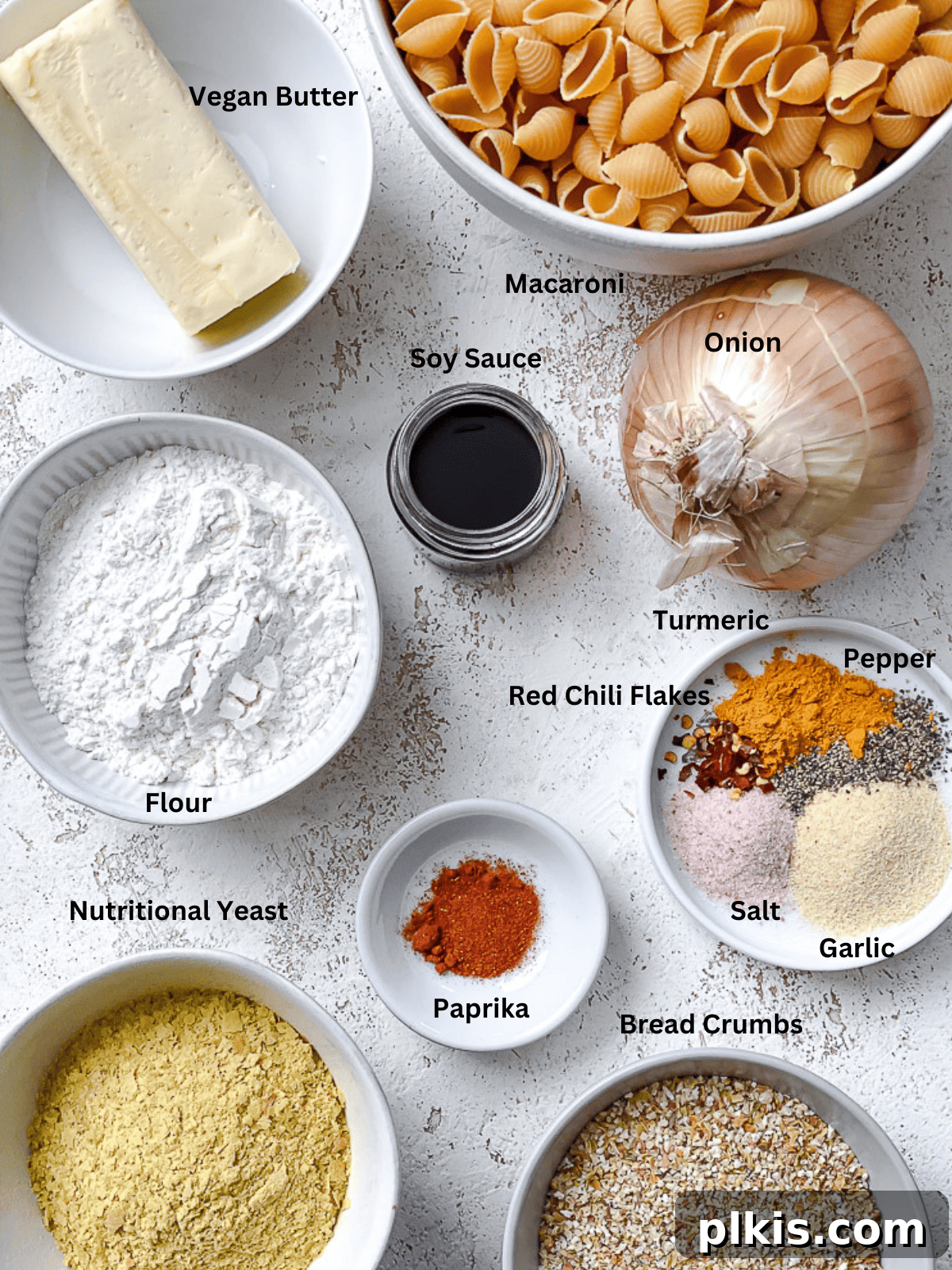 Ultimate Vegan Mac Bake 3 Various ingredients for Vegan Baked Mac and Cheese laid out on a white surface.