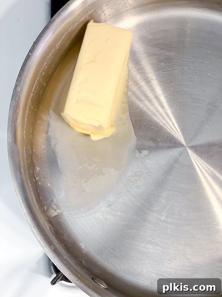 Ultimate Vegan Mac Bake 5 Process shot showing vegan butter melting in a large saucepan.
