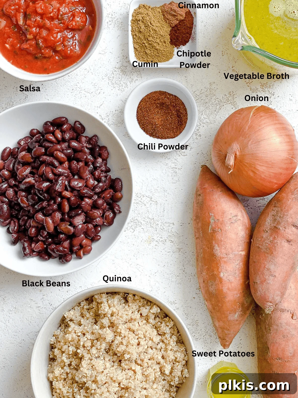 Hearty Sweet Potato Quinoa Chili 3 A close-up shot of key ingredients for Sweet Potato Quinoa Chili laid out, including diced sweet potatoes, black beans, salsa, and aromatic spices.