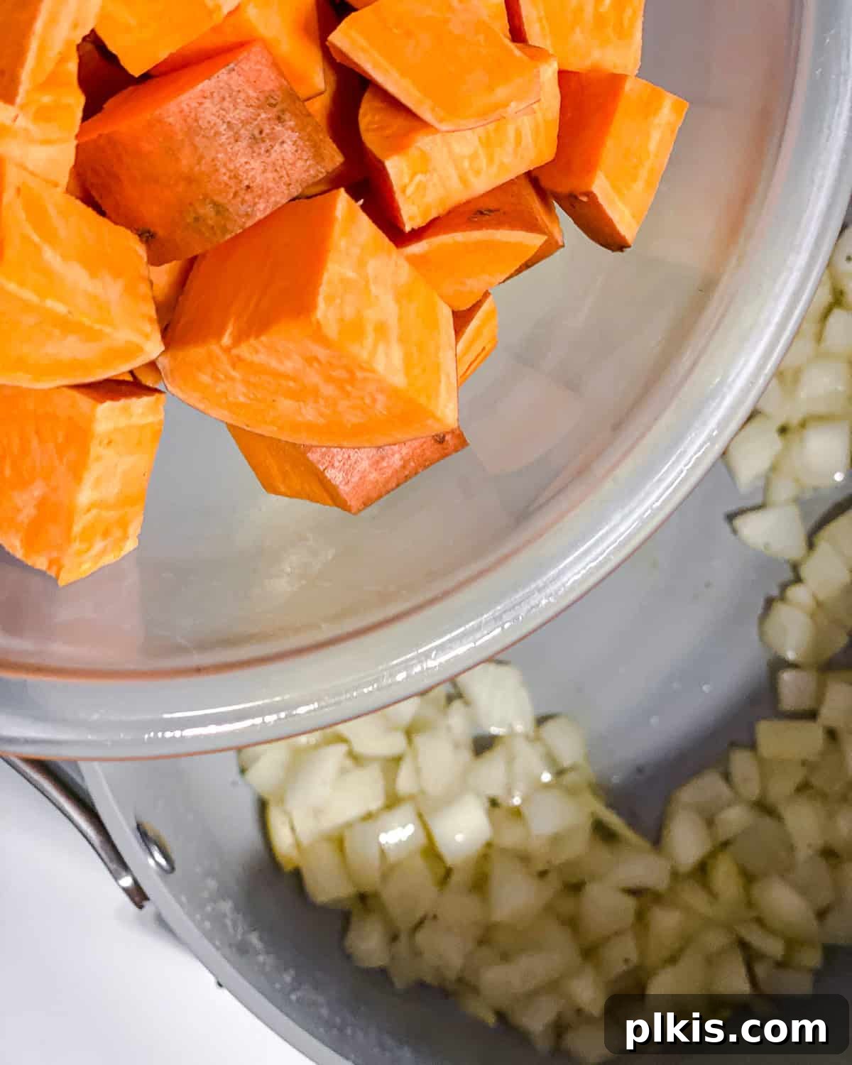 Hearty Sweet Potato Quinoa Chili 5 Process shot illustrating cubed sweet potatoes being added to the sautéed onions in a heavy-based pot, ready to absorb the rich flavors.