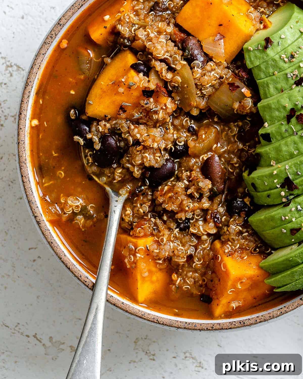 Hearty Sweet Potato Quinoa Chili 9 A close-up of a steaming bowl of finished Sweet Potato Quinoa Chili, showing its rich texture and colorful ingredients, perfectly garnished.