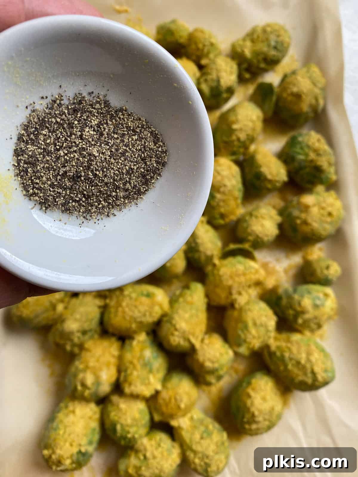 Effortless Vegan Brussels Sprouts Delight 11 Seasoning the Brussels sprouts with salt and pepper on the baking sheet